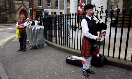 A woman plays the bagpipes during the Edinburgh festival