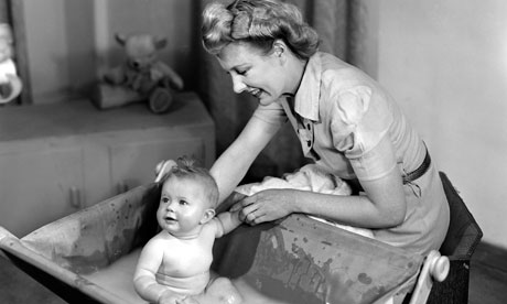 Woman bathing a baby, 1948.