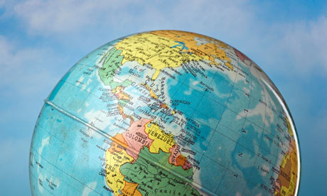 Globe against cloudy sky