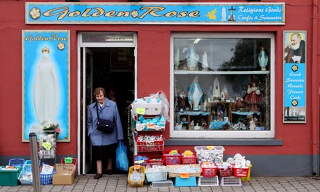 Living on a prayer … a woman exits a Roman Catholic memorabilia shop in Knock, County Mayo, Ireland.