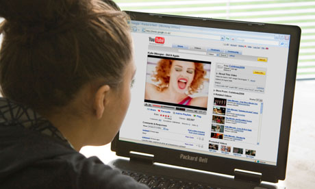 Girl watches Kylie Minogue music video on YouTube