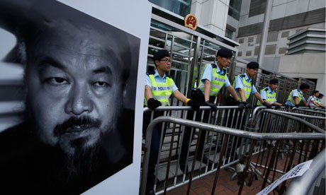 Ai Weiwei's face on a poster placed outside the Chinese liaison office in Hong Kong on 10 April