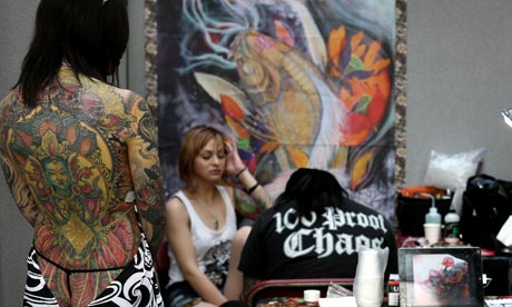 london tattoo convention Artist at work A woman adds to her collection of 