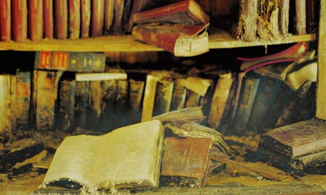 Row of dusty books on a shelf