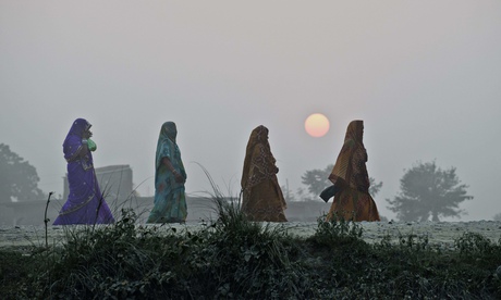 TOPSHOTS Hindu women walk on a country r