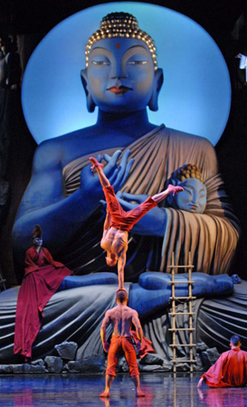 A scene from Monkey: Journey to the West featuring acrobatic balancing and a large Buddha Statue