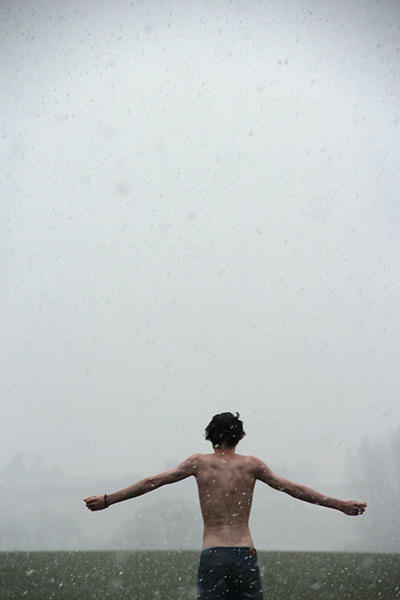 Photography competition: topless man arms outstretched in the rain