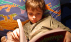 Young boy reading a book 