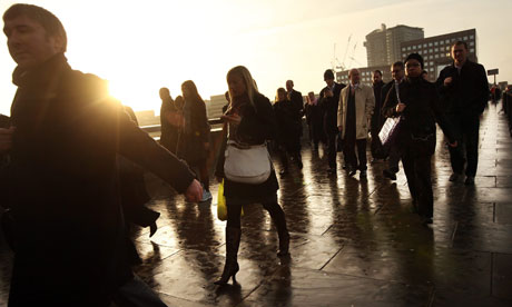 City workers walk across London Bridge