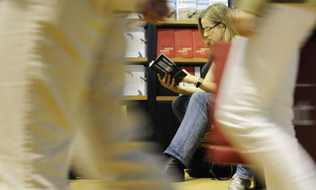 A woman reads a book while at the Frankfurt Book Fair 2008