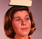 Woman balances book on her head