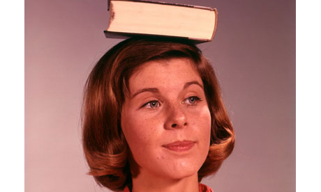 Woman balances book on her head