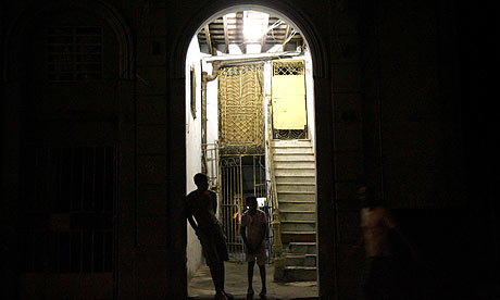 People stand outside their house in Havana