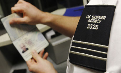 UK Border agent checks a passport