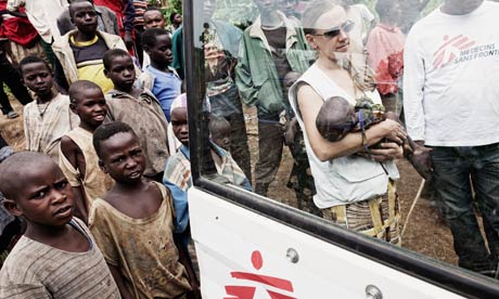 An MSF nurse carries a baby suffering from malnutrition in the Democratic Republic of the Congo