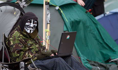 A protester sits outside at the Occupy London camp at St Pauls cathedral