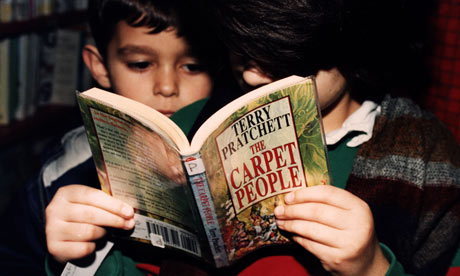 Children reading a Terry Pratchett novel