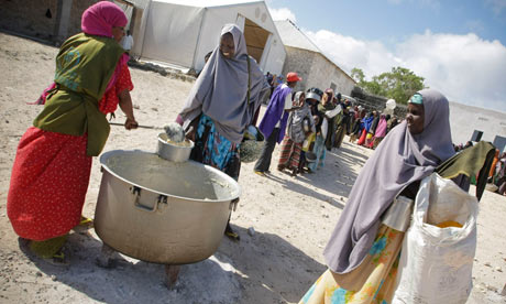 Women and children queue to receive food at a distribution centre in Mogadishu