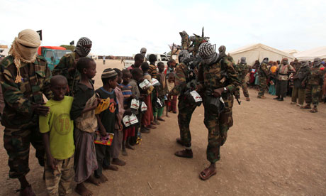 Al-Shabaab fighters distribute relief to internally displaced people at K50 camp