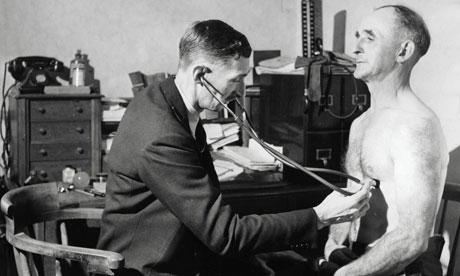 A doctor examines a middle-aged man in 1948