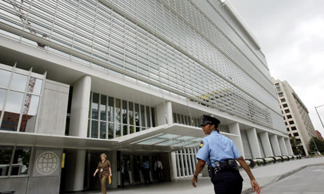 A private security officer stands watch outside of the headquarters of the World Bank in Washington