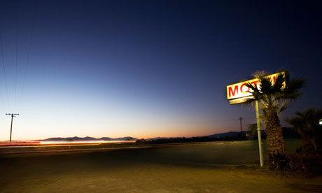 Motel sign along highway at night