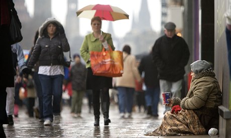 The city and the city … a woman begs on Princes Street in Edinburgh.