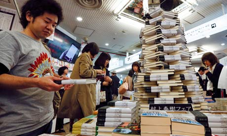 Japanese readers flip through Japanese novelist Haruki Murakami's new book
