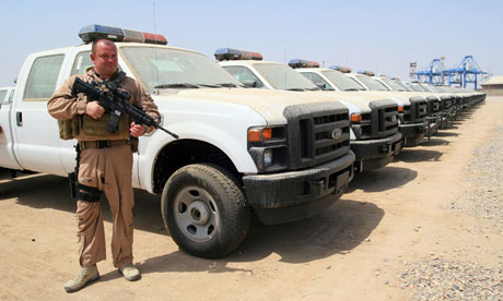 Dogs of war … an Aegis private security detail guards US-made trucks following their delivery to Ira