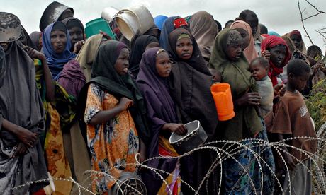 Heat and dust: displaced Somalis wait for food at the Badbaado refugee camp near Mogadishu.