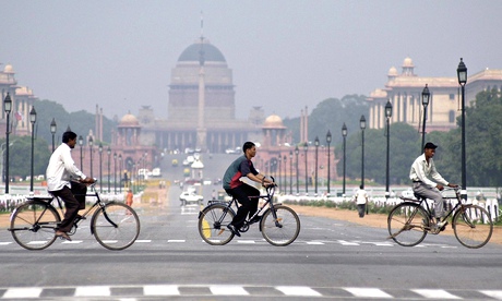 Cyclists pass Lutyens’s Rashtrapati Bhavan in New Delhi. 