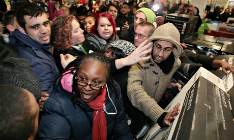 Stuff and nonsense … shoppers scuffling over a TV in the Wembley branch of Asda during the Black Fri