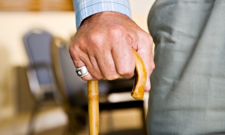 An elderly man holding a walking stick