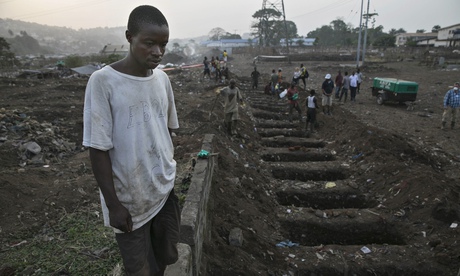 Horror … a gravedigger takes a break in Freetown, Sierra Leone, during the most recent Ebola outbrea