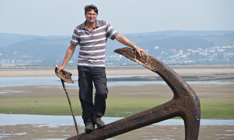 Armitage at Appledore, in north Devon, with the walking stick he cut from a holly bush in his garden