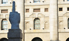 A sculpture by the Italian artist Maurizio Cattelan in front of Milan's stock exchange. 