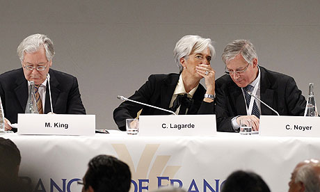 IMF chief Christine Lagarde whispers to France's central bank governor Christian Noyer