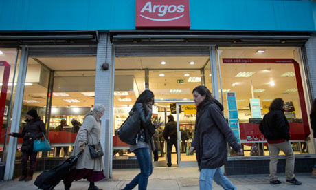 Shoppers walk past an Argos store in London