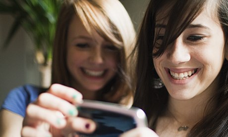 Two teenage girls using smartphone