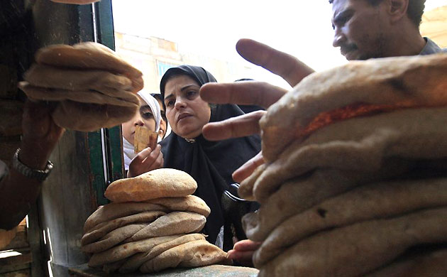 Woman queues for bread in Cairo, Egypt