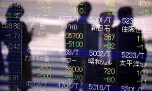 A Nikkei stock indicator board in downtown Tokyo shows the latest slump in Japanese stocks
