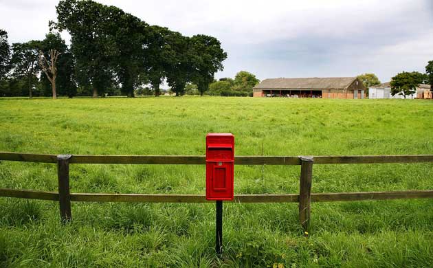 A Royal Mail postbox in a rural area of Suffolk