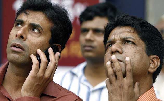 Indian investors watch share prices outside the Bombay Stock Exchange
