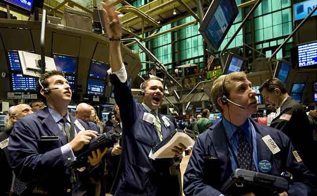 Traders on the floor of the New York stock exchange await the announcement of the Federal Reserve interest rate adjustment