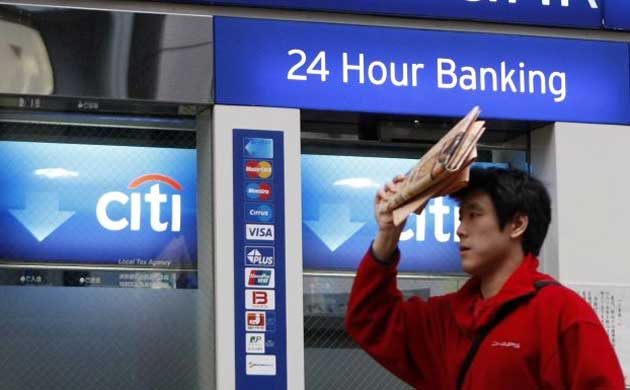 A man walks past a Citibank branch in Tokyo on the day that  the US government agreed to inject $20bn into the struggling  Citigroup. Photograph: Toru Hanai