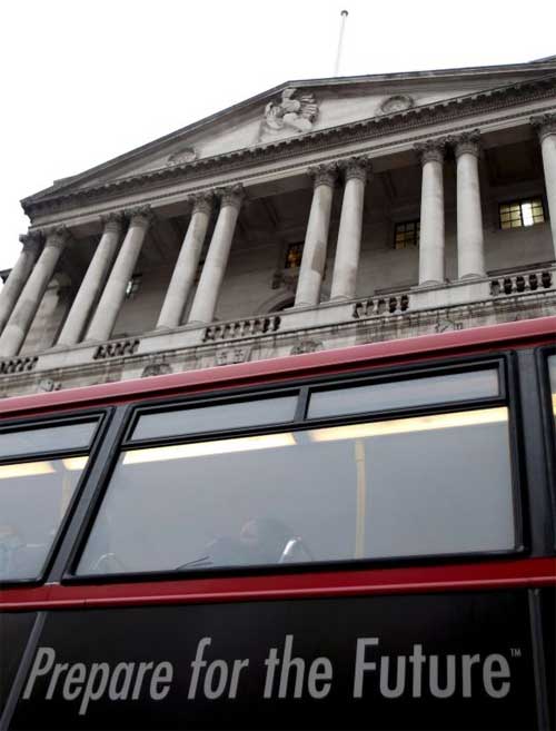 A London bus passes the Bank of England