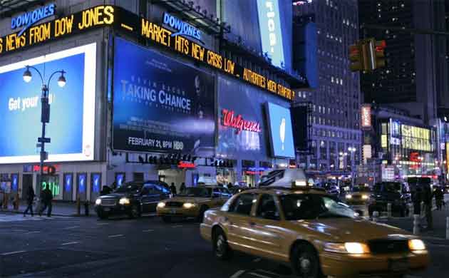 A Times Square billboard displays news of the Dow Jones index fall