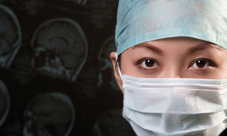 Female doctor facemask Fewer than 30 of consultant posts in the NHS are 