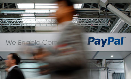 Visitors walk past an Ebay and PayPal banner at the Mobile World Congress in Barcelona