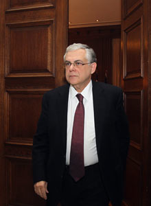 Greek prime minister Lucas Papademos enters the meeting room at Maximos mansion on Feb 8, 2012.